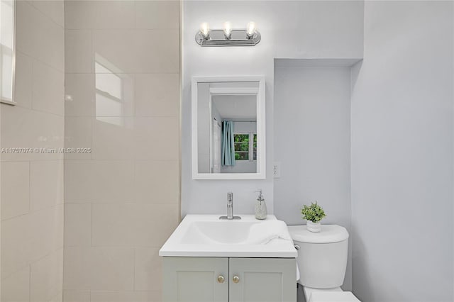 bathroom with toilet and vanity