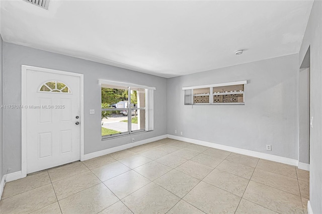 foyer entrance featuring light tile patterned flooring, visible vents, and baseboards