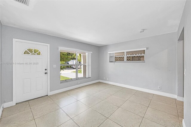 5248 N Andrews Ave, Oakland Park, FL 33309 - entryway featuring baseboards and light tile patterned flooring