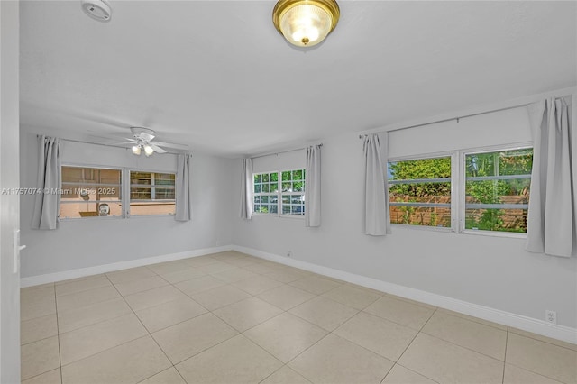 unfurnished room featuring ceiling fan, baseboards, and tile patterned flooring