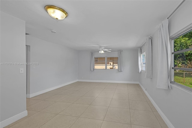 5248 N Andrews Ave, Oakland Park, FL 33309 - spare room with light tile patterned floors, ceiling fan, plenty of natural light, and baseboards