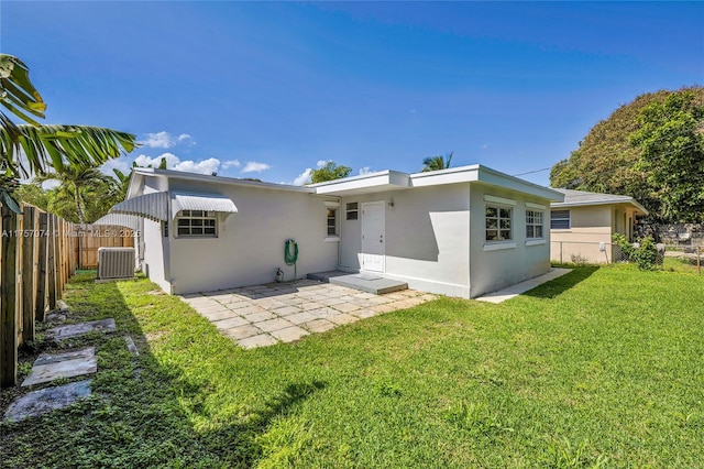 rear view of property featuring a yard, stucco siding, a patio area, fence, and cooling unit