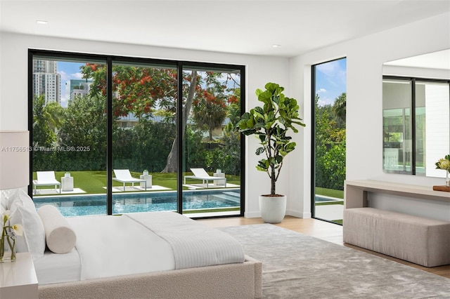 6991 SW 91st St, Pinecrest, FL 33156 - bedroom featuring multiple windows, wood finished floors, and access to exterior