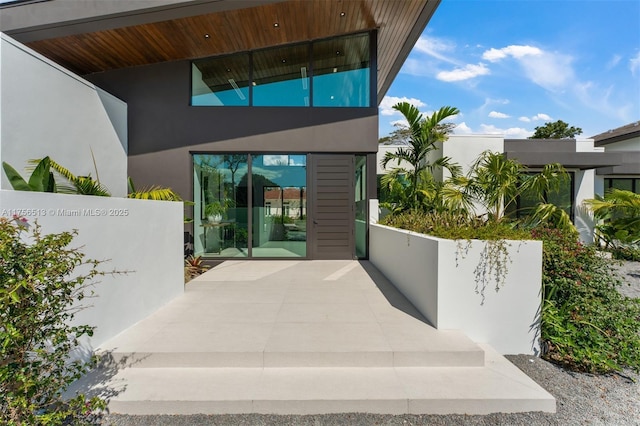 6991 SW 91st St, Pinecrest, FL 33156 - view of exterior entry featuring stucco siding and a patio
