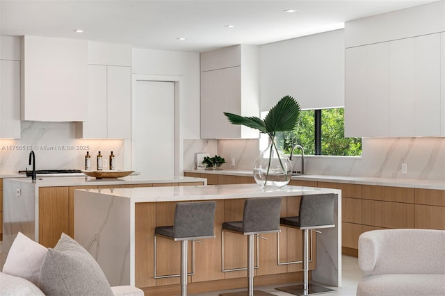 6991 SW 91st St, Pinecrest, FL 33156 - kitchen with modern cabinets, tasteful backsplash, and recessed lighting