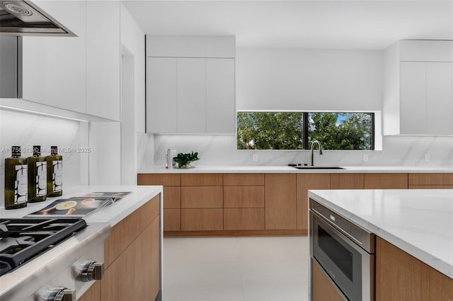6991 SW 91st St, Pinecrest, FL 33156 - kitchen featuring modern cabinets, exhaust hood, appliances with stainless steel finishes, decorative backsplash, and white cabinets