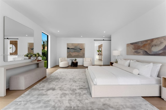 6991 SW 91st St, Pinecrest, FL 33156 - bedroom featuring a barn door, wood finished floors, and recessed lighting