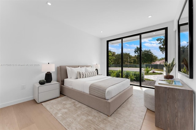 6991 SW 91st St, Pinecrest, FL 33156 - bedroom with multiple windows, light wood-style floors, access to outside, and a wall of windows