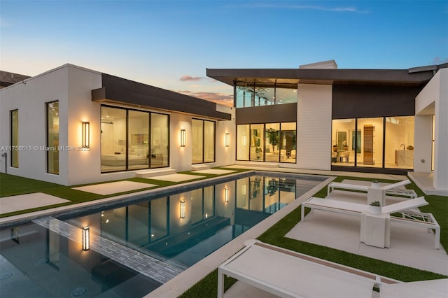 6991 SW 91st St, Pinecrest, FL 33156 - back of house featuring an outdoor pool, a patio, and stucco siding