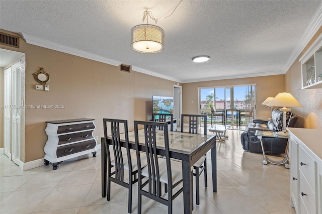 dining room with ornamental molding, light tile patterned flooring, and visible vents