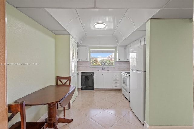 kitchen featuring light tile patterned floors, light countertops, decorative backsplash, a sink, and white appliances