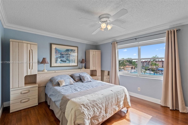 bedroom with crown molding, a ceiling fan, a textured ceiling, wood finished floors, and baseboards