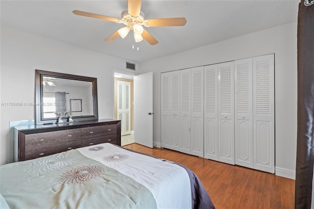 bedroom featuring a ceiling fan, light wood-type flooring, visible vents, and baseboards