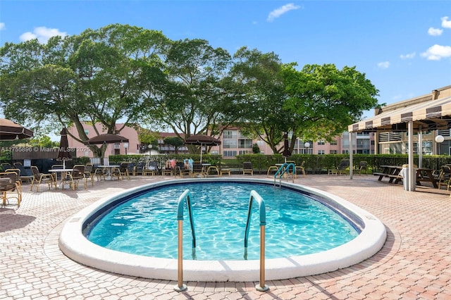 view of pool featuring fence