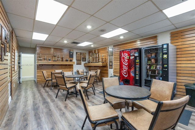 dining room with a paneled ceiling, visible vents, and wood finished floors