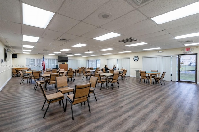 dining room featuring wood finished floors, visible vents, and baseboards