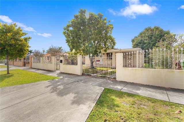 view of gate with a fenced front yard