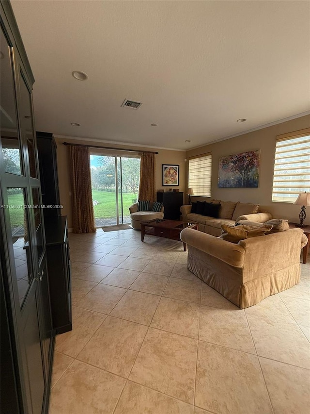 living room with ornamental molding, recessed lighting, visible vents, and light tile patterned flooring