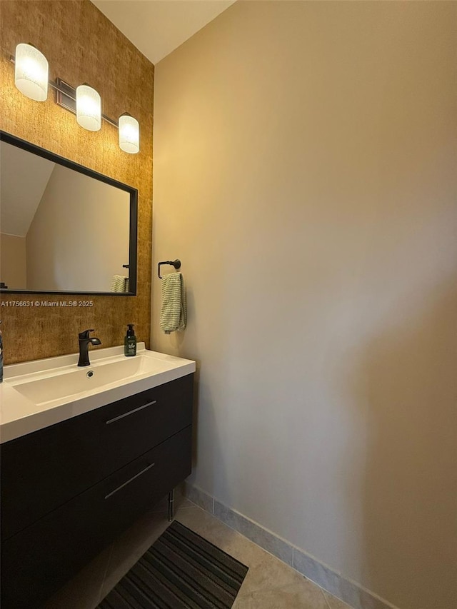 bathroom featuring tile patterned flooring, baseboards, and vanity