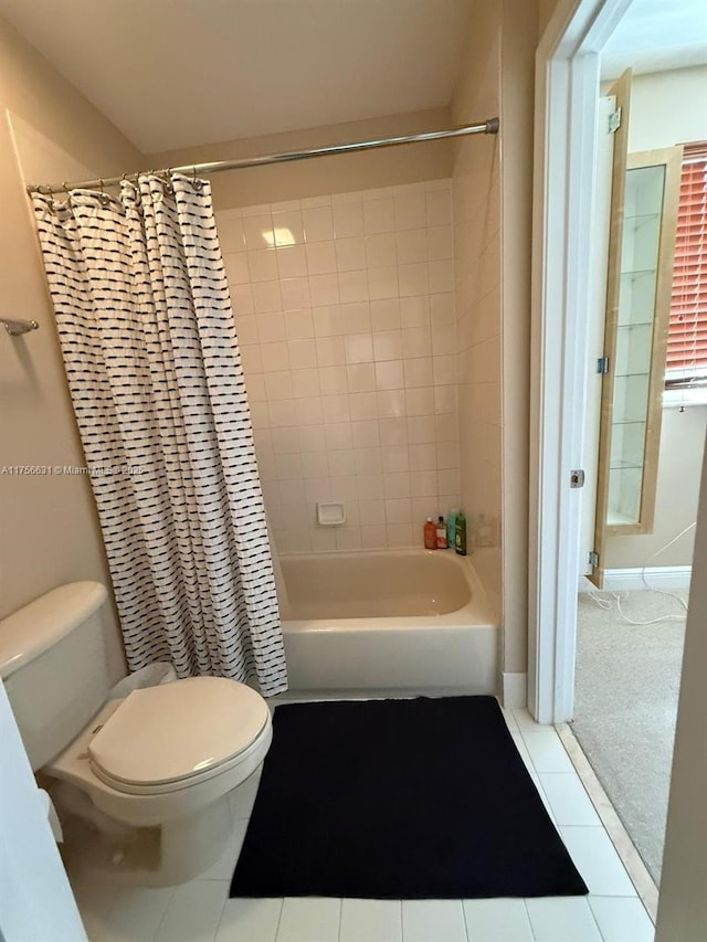 bathroom featuring shower / bath combo, toilet, and tile patterned floors