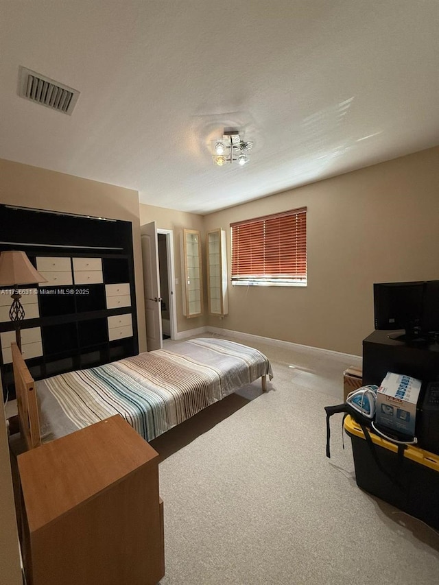 bedroom featuring carpet, visible vents, and baseboards