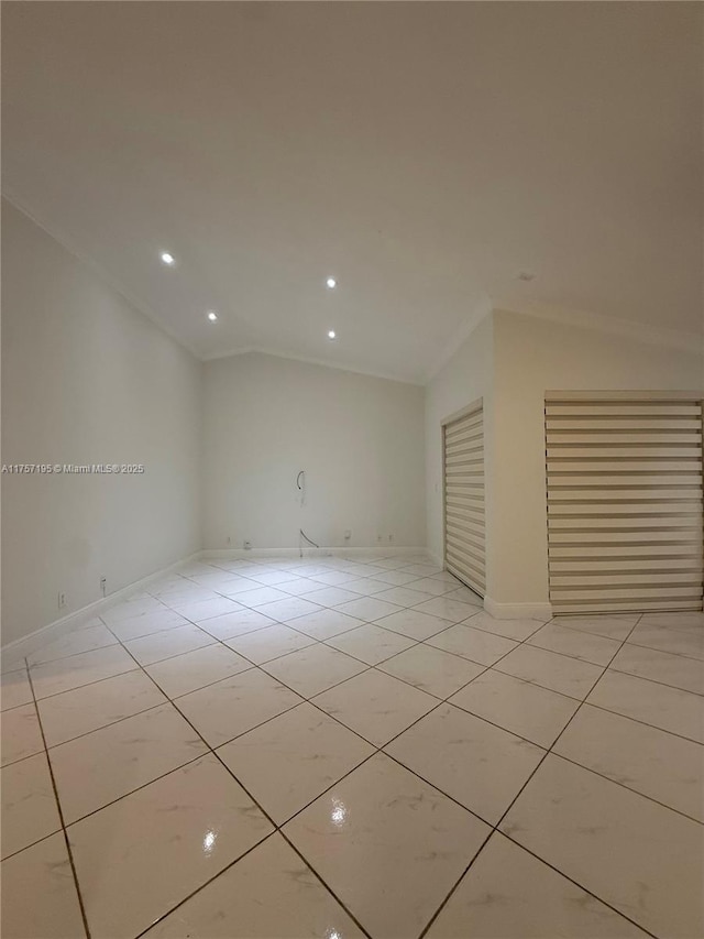 spare room with vaulted ceiling, light tile patterned floors, recessed lighting, and baseboards