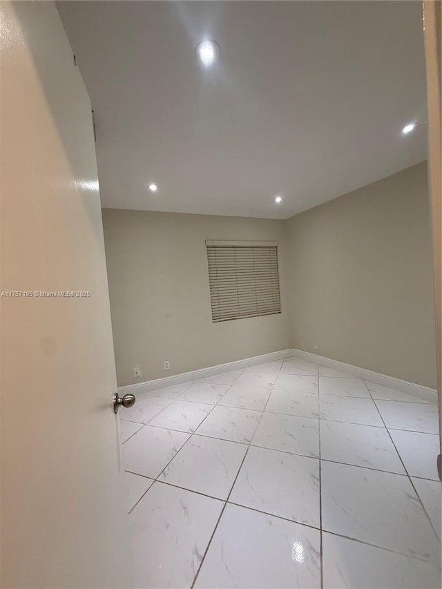 empty room with recessed lighting and baseboards