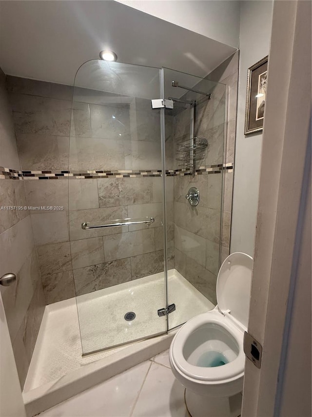 full bath with a stall shower and toilet