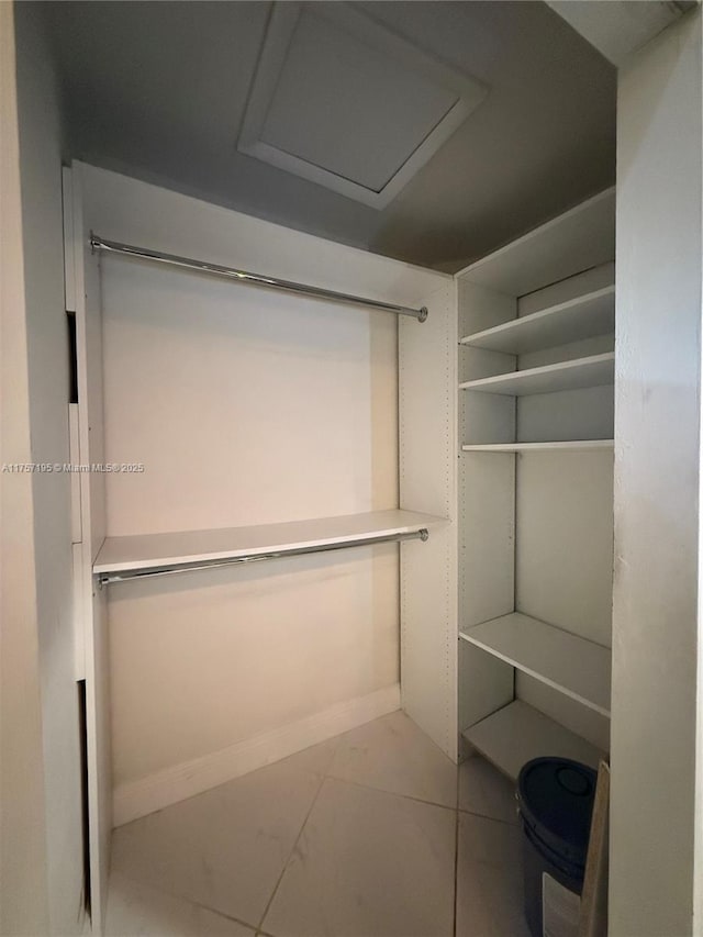 spacious closet featuring attic access