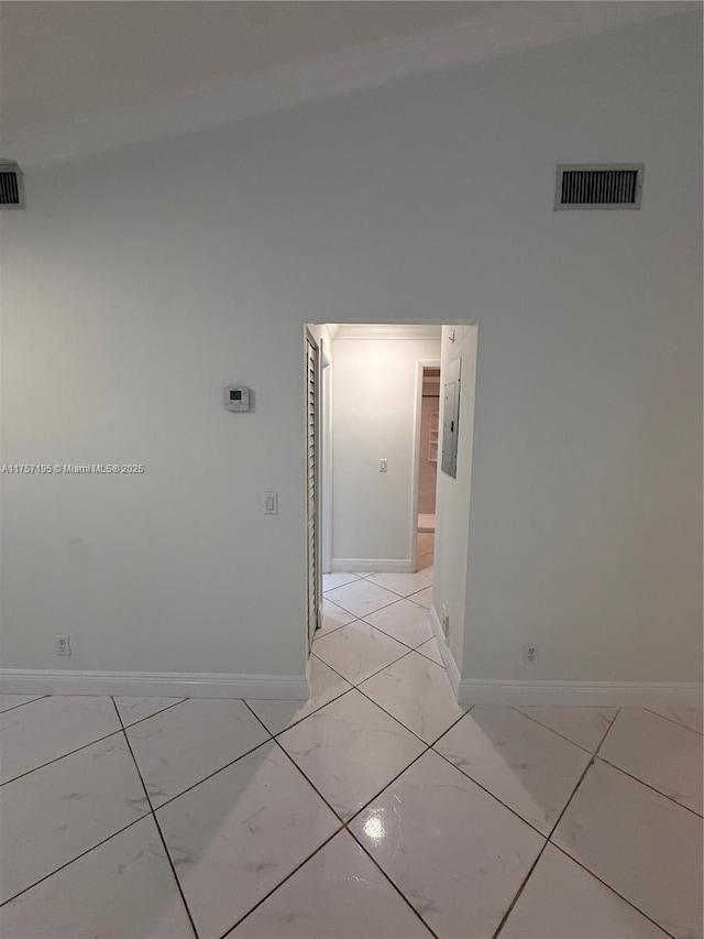 empty room featuring marble finish floor, visible vents, electric panel, and baseboards