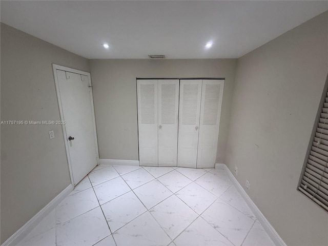 unfurnished bedroom with recessed lighting, marble finish floor, visible vents, and baseboards