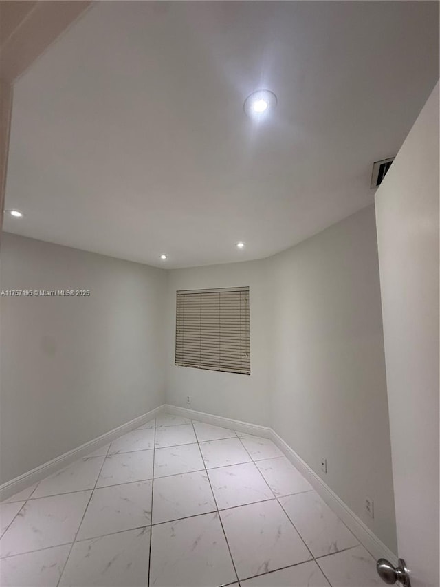 spare room featuring visible vents, baseboards, and recessed lighting