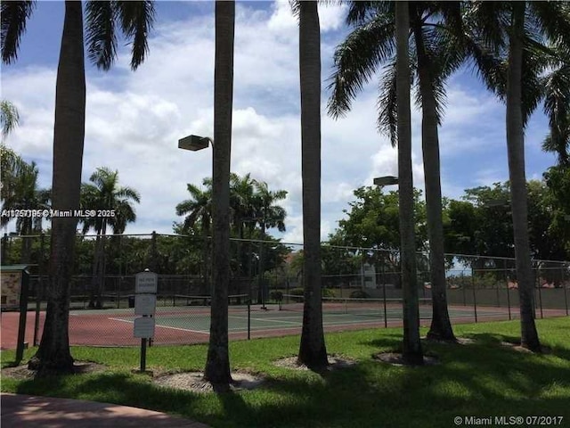 view of tennis court featuring fence