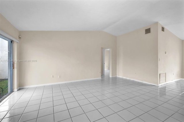 spare room with lofted ceiling, visible vents, and light tile patterned flooring