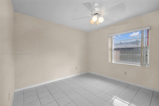 unfurnished room with baseboards, a ceiling fan, and light tile patterned flooring