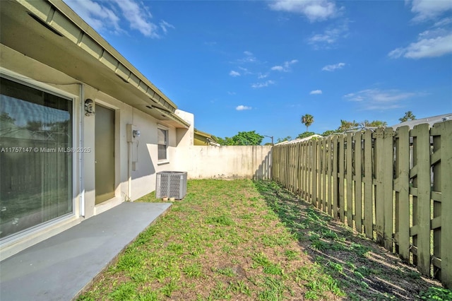 view of yard featuring central AC and a fenced backyard