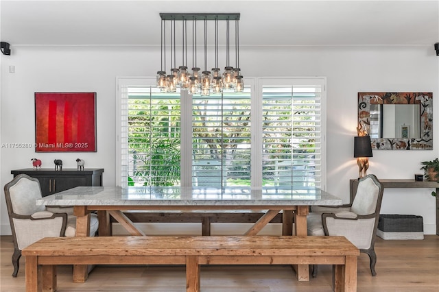 dining space with an inviting chandelier and wood finished floors