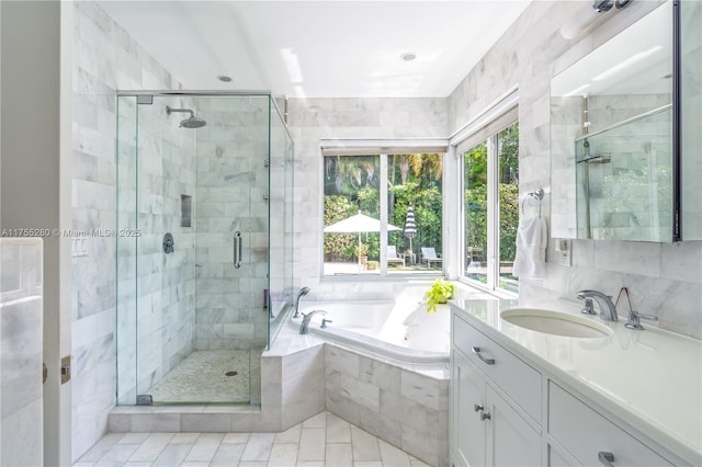 bathroom with vanity, a bath, a stall shower, and tile patterned flooring