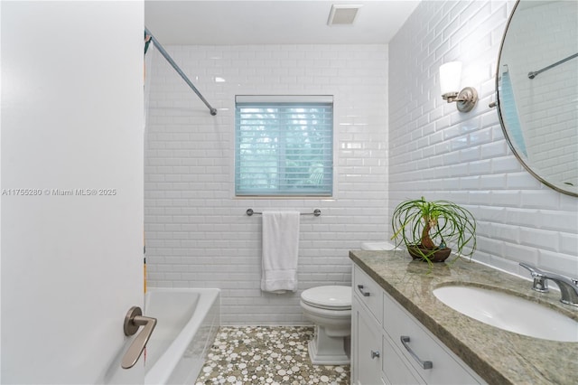 bathroom featuring visible vents, tile walls, tile patterned flooring, vanity, and toilet