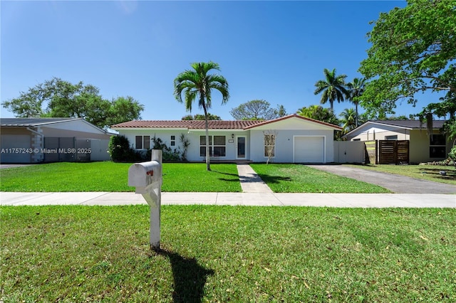 ranch-style home featuring a front lawn, a tile roof, aphalt driveway, fence, and a garage