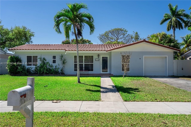 ranch-style home with stucco siding, driveway, a front lawn, a tile roof, and a garage