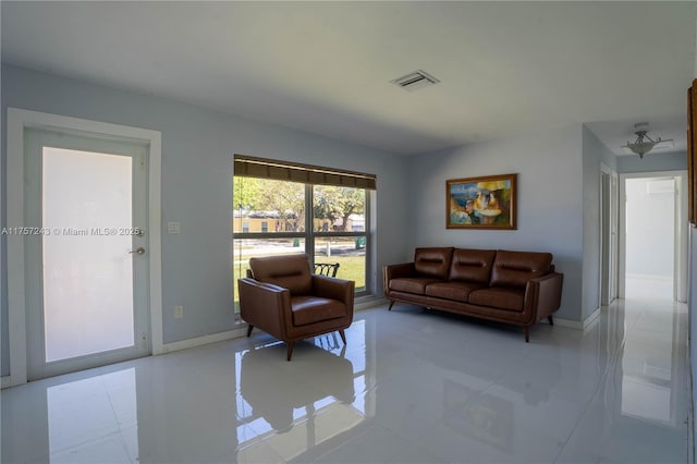 living area with visible vents and baseboards