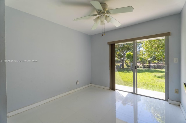 spare room featuring baseboards and a ceiling fan