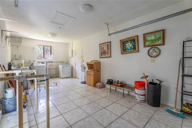 interior space with light tile patterned floors, independent washer and dryer, and attic access