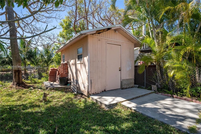 view of shed featuring fence