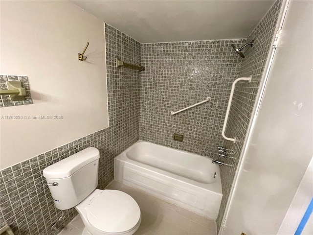 bathroom with shower / bath combination, tile walls, and toilet