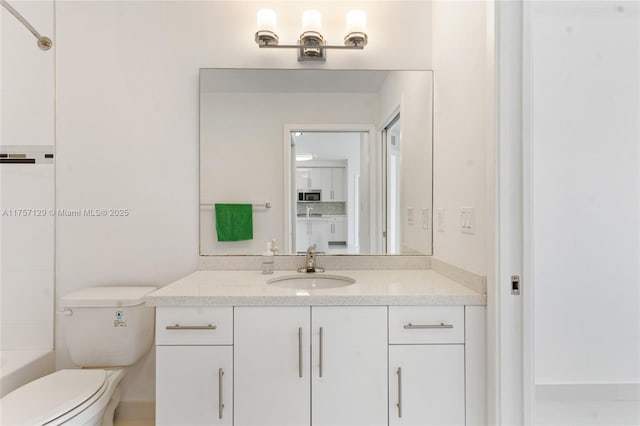 bathroom featuring toilet and vanity