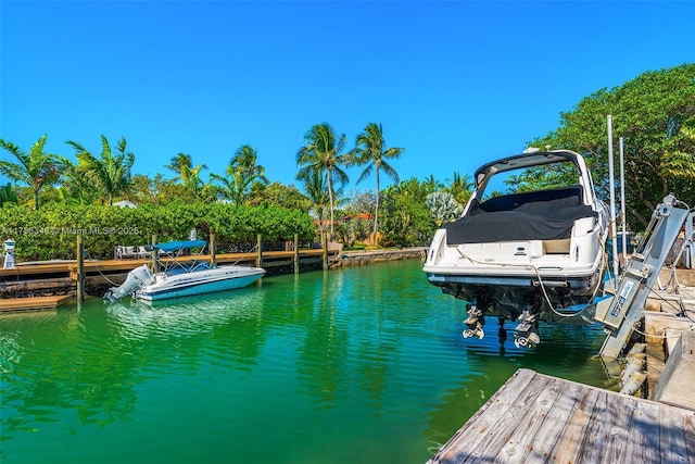 dock area with a water view and boat lift