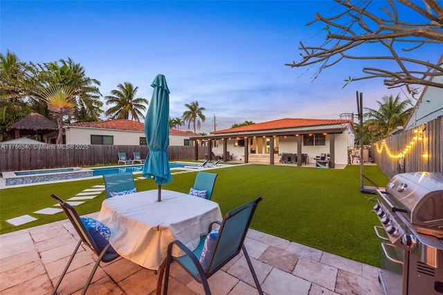 view of patio / terrace featuring grilling area, a fenced backyard, a fenced in pool, and outdoor dining area