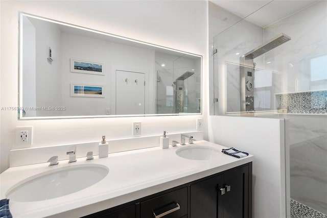 bathroom with a shower stall, double vanity, and a sink